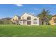 Spacious backyard featuring lush green grass and a view of the home's exterior at 4432 Huddlestone Dr, Wesley Chapel, FL 33545