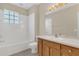 Bathroom featuring a tub and shower combo and a vanity with sink and mirror at 4432 Huddlestone Dr, Wesley Chapel, FL 33545