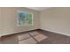 Bedroom features hardwood floors and a large picture window overlooking a green yard at 4432 Huddlestone Dr, Wesley Chapel, FL 33545