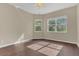 Bright bedroom with hardwood floors, a ceiling fan, and a view of lush greenery at 4432 Huddlestone Dr, Wesley Chapel, FL 33545