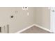 Neutral colored laundry room with washer and dryer hook ups and tiled floor at 4432 Huddlestone Dr, Wesley Chapel, FL 33545