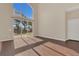 Sun-filled living space with expansive windows and hardwood floors at 4432 Huddlestone Dr, Wesley Chapel, FL 33545