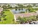 Community aerial view with lush landscaping, a tranquil pond, and convenient parking at 4722 67Th N Ave, Pinellas Park, FL 33781