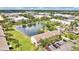 Aerial view showcasing a pond and the surrounding multi-Gathering residential buildings and industrial area at 4722 67Th N Ave, Pinellas Park, FL 33781