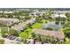 Aerial view featuring multiple townhomes with scenic pond and lush landscaping in the residential neighborhood at 4722 67Th N Ave, Pinellas Park, FL 33781