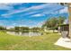 Scenic backyard with a serene pond view, combining nature and comfortable living at 4722 67Th N Ave, Pinellas Park, FL 33781