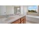 Bright bathroom featuring a double sink vanity, separate shower, and a soaking tub at 4722 67Th N Ave, Pinellas Park, FL 33781