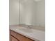 Bathroom vanity with light countertop, wooden cabinets, and large mirror at 4722 67Th N Ave, Pinellas Park, FL 33781