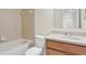 A bathroom with a tiled shower and bath, toilet, and wooden vanity under a large mirror at 4722 67Th N Ave, Pinellas Park, FL 33781