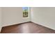 Bright bedroom with window, featuring wood-style flooring and crisp white walls at 4722 67Th N Ave, Pinellas Park, FL 33781