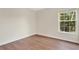 A well-lit room features wood-style flooring and a window providing ample natural light at 4722 67Th N Ave, Pinellas Park, FL 33781