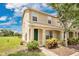 Charming townhome with a well-manicured front yard and a welcoming green front door entrance at 4722 67Th N Ave, Pinellas Park, FL 33781