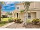 Beautiful townhome featuring a well-kept lawn and colorful landscaping enhancing curb appeal at 4722 67Th N Ave, Pinellas Park, FL 33781