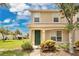 Charming two-story home featuring a well-kept lawn, a green front door, and colorful landscaping at 4722 67Th N Ave, Pinellas Park, FL 33781