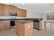 Spacious kitchen featuring a center island with seating, stainless steel appliances, and an open floor plan at 4722 67Th N Ave, Pinellas Park, FL 33781
