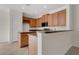 Well-lit kitchen featuring tile floors, wood cabinets, an island with seating, and modern appliances at 4722 67Th N Ave, Pinellas Park, FL 33781