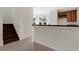 Open-concept kitchen and staircase featuring dark wood steps and bar seating, a wine rack, and tiled floor at 4722 67Th N Ave, Pinellas Park, FL 33781