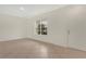 Inviting living area featuring neutral tile, crown molding, and a large window for plenty of natural light at 4722 67Th N Ave, Pinellas Park, FL 33781
