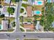 An aerial view showing the house with the lawn, mature trees, and a neighborhood street at 7824 Starkey Rd, Seminole, FL 33777