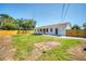 Large, grassy backyard surrounded by a wooden fence, offering privacy and ample space at 7824 Starkey Rd, Seminole, FL 33777