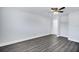 A simple empty bedroom with new flooring, updated ceiling fan, leading to ensuite bathroom at 7824 Starkey Rd, Seminole, FL 33777
