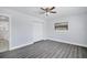 Bright bedroom with hardwood floors, ceiling fan, window, closet and an accessible bathroom at 7824 Starkey Rd, Seminole, FL 33777