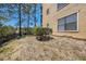 Backyard featuring a small bush and partial view of the home's exterior at 11901 4Th N St # 2107, St Petersburg, FL 33716