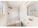 Modern bathroom featuring marble-style shower, updated vanity, and great natural light from the window at 11901 4Th N St # 2107, St Petersburg, FL 33716
