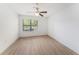 This bedroom boasts a ceiling fan, bright natural light, and sleek wood-look flooring at 11901 4Th N St # 2107, St Petersburg, FL 33716