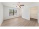 Bright bedroom features a large window, ceiling fan, and a walk-in closet with shelving for ample storage at 11901 4Th N St # 2107, St Petersburg, FL 33716