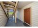 Condominium entrance featuring a brown front door, stairs and neutral exterior with unit number 2107 at 11901 4Th N St # 2107, St Petersburg, FL 33716