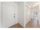 Bright entryway with wood-look flooring, white walls, leading to a spacious room with a ceiling fan at 11901 4Th N St # 2107, St Petersburg, FL 33716