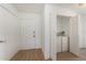 Bright entryway features wood-look flooring, white walls, and a convenient laundry closet with washer and dryer at 11901 4Th N St # 2107, St Petersburg, FL 33716