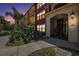 Inviting exterior view showcasing a red condominium building with lush landscaping and architectural details at 11901 4Th N St # 2107, St Petersburg, FL 33716