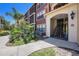 Inviting exterior view showcasing a red condominium building with lush landscaping and architectural details at 11901 4Th N St # 2107, St Petersburg, FL 33716