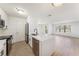 Bright open-plan area with laminate floors, white walls, and a modern kitchen with stainless appliances at 11901 4Th N St # 2107, St Petersburg, FL 33716