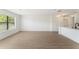Bright open-plan area with laminate floors, white walls, and a combined living, dining, and kitchen area at 11901 4Th N St # 2107, St Petersburg, FL 33716