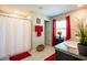 Bathroom features a shower with a white curtain and red accents at 11910 Field Thistle Ct, Riverview, FL 33579