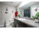 Bathroom with granite countertop, white sink, framed art on the wall, and decorative potted plants for a splash of color at 11910 Field Thistle Ct, Riverview, FL 33579