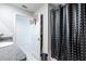 Bathroom with granite countertop, white sink, shower with black and white shower curtain, and a basketball hoop on the door at 11910 Field Thistle Ct, Riverview, FL 33579