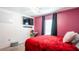 Bedroom with a red bedspread, a modern ceiling fan, and dark curtains at 11910 Field Thistle Ct, Riverview, FL 33579