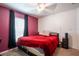 Comfortable bedroom featuring a bed with a red blanket, a window, and a closet at 11910 Field Thistle Ct, Riverview, FL 33579