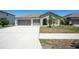 Charming single-story home with a three-car garage and well-manicured front yard at 11910 Field Thistle Ct, Riverview, FL 33579
