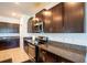 Kitchen features granite countertops, dark cabinets and stainless steel appliances at 11910 Field Thistle Ct, Riverview, FL 33579