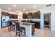 Kitchen featuring dark cabinets, stainless steel appliances, granite countertops and a center island with bar stool seating at 11910 Field Thistle Ct, Riverview, FL 33579
