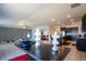 Open concept living and kitchen area with modern decor, tile flooring, and plenty of natural light to enjoy at 11910 Field Thistle Ct, Riverview, FL 33579