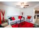 Bright living room featuring a ceiling fan, sofa with throw pillows, area rug and neutral walls at 11910 Field Thistle Ct, Riverview, FL 33579