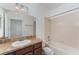 Well-lit bathroom with a combination tub and shower, and a granite-style vanity top at 13188 Royal Pines Ave, Riverview, FL 33579
