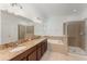 Elegant bathroom featuring dual sinks, a soaking tub, and a separate glass shower at 13188 Royal Pines Ave, Riverview, FL 33579