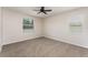 Cozy bedroom featuring neutral walls, plush carpet, and an abundance of natural light at 13188 Royal Pines Ave, Riverview, FL 33579